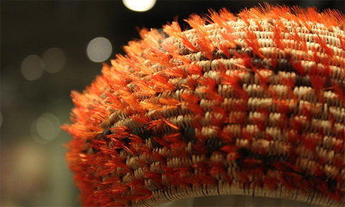 Basket with woodpecker feathers